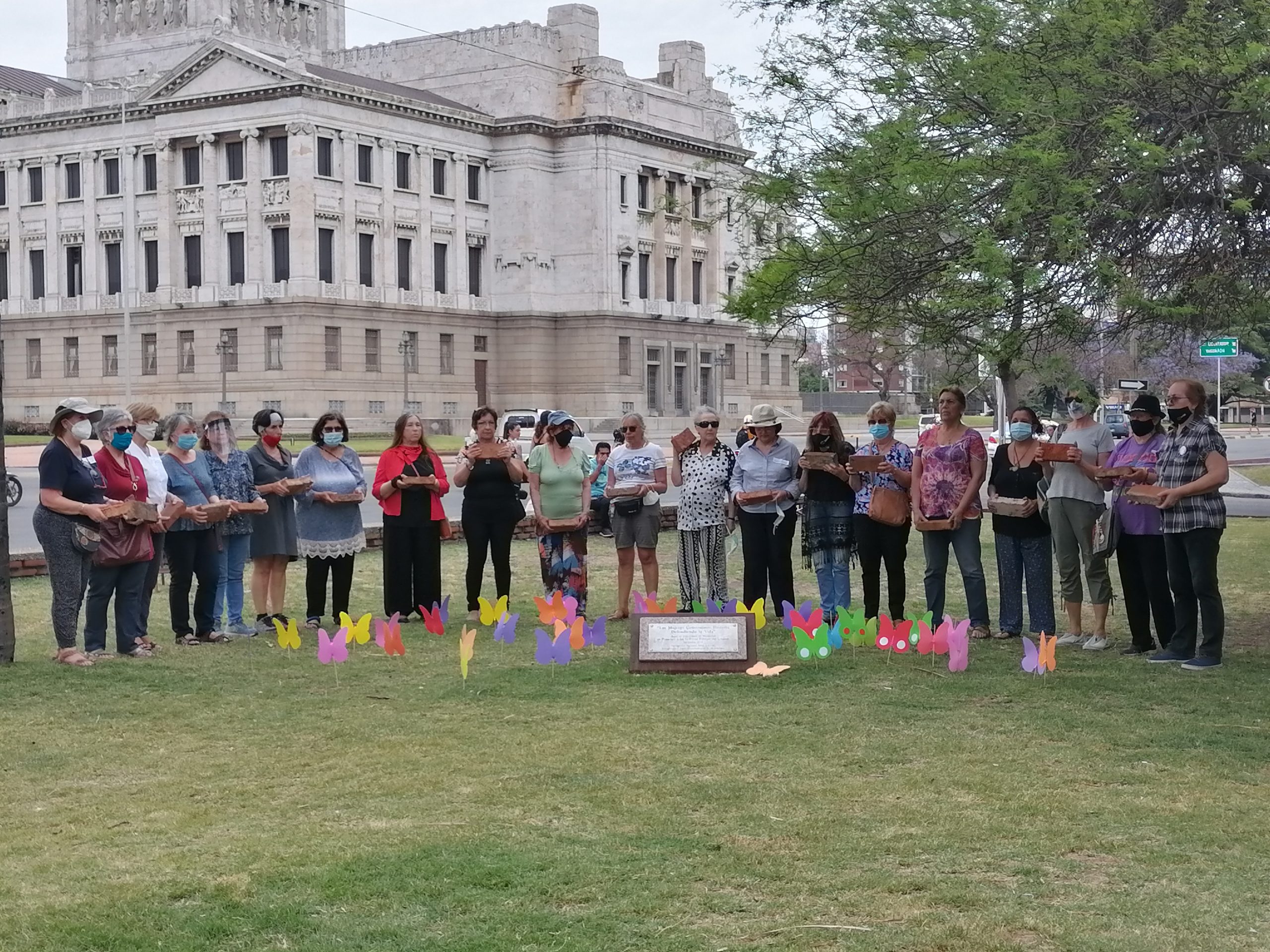 Parte del grupo de mujeres Ex Presas Políticas junto a la piedra fundamental que se puso hace tres años frente al Palacio Legislativo.